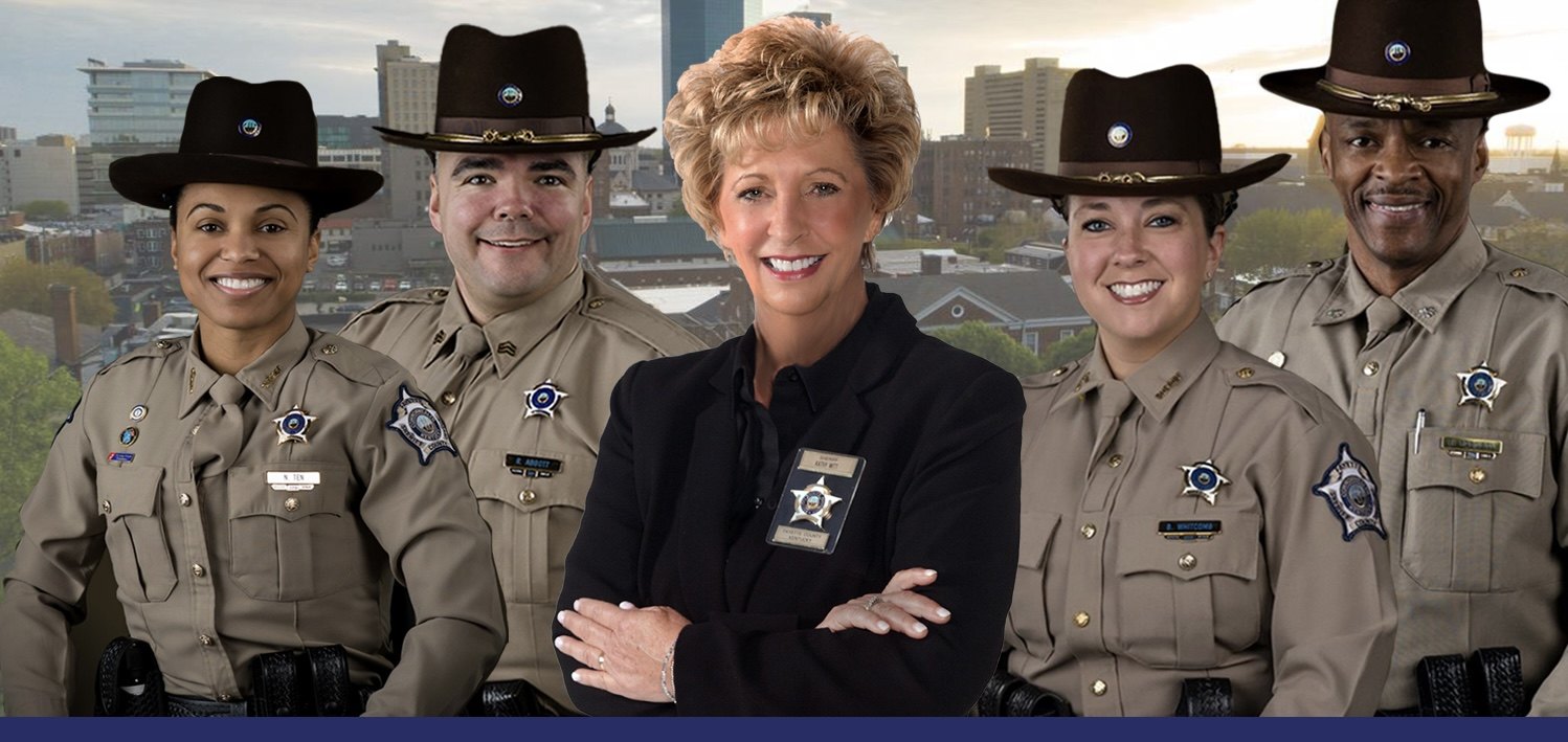 Sheriff Kathy H. Witt with Fayette County Sheriff's deputies in front of the Lexington, Kentucky skyline.